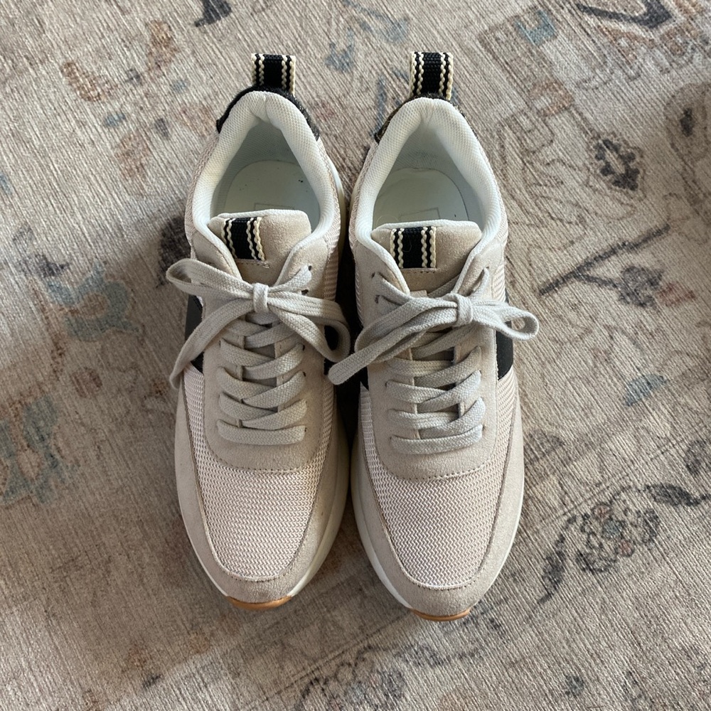 Cream and black sneakers with gold details